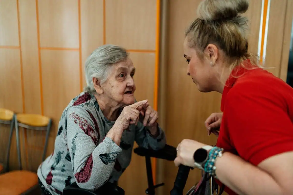 Older woman talking with a caregiver about her everyday support needs
