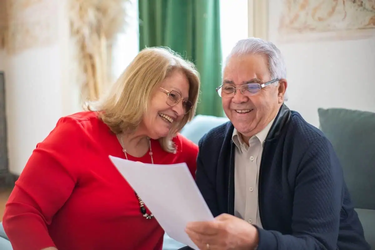 Elderly couple reading a document together about aged care reform 2022