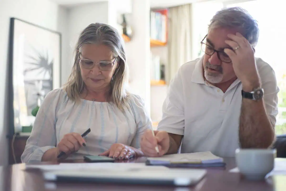 Senior couple working through their finances after the 2021 – 2022 budget
