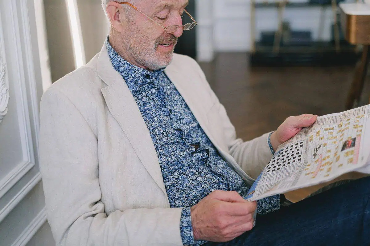 Elderly man reading the news about the royal commission into aged care